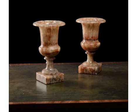 A pair of Derbyshire fluorspar campana urns, first half 19th century, each with flared rim and bulbous base, with waisted soc