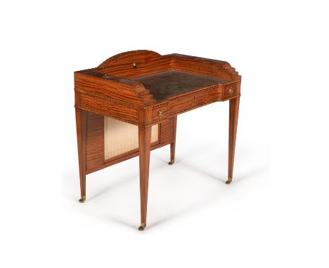 A Victorian satinwood writing table, circa 1890, in George III style, directly after a design by Thomas Sheraton, inlaid with