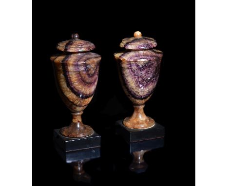 A pair of fine late George III Blue John solid ornamental urns in Neoclassical style, late 18th/early 19th century, the ovoid