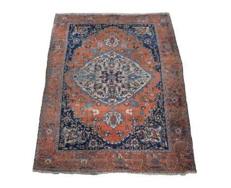 A Serapi carpet, decorated throughout with stylised foliate and floral motifs, the cream medallion within a madder field and 