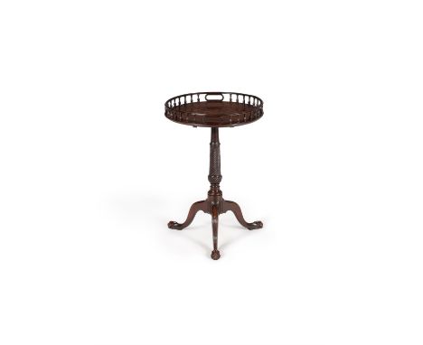 A George III mahogany tripod table, circa 1770, the circular top with spindle gallery incorporating carrying handles, above t