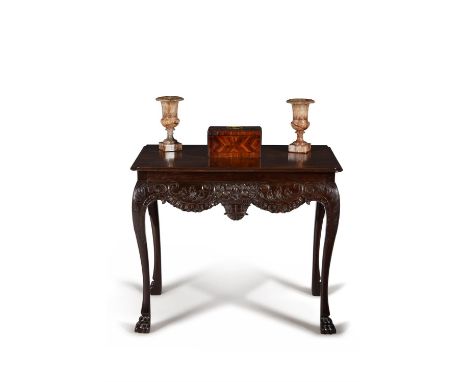 A George II Irish carved mahogany console or side table, circa 1750, the rectangular top with rounded front corners and mould