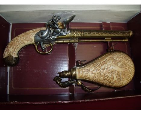 Boxed reproduction brass barreled flintlock pistol and powder flask 