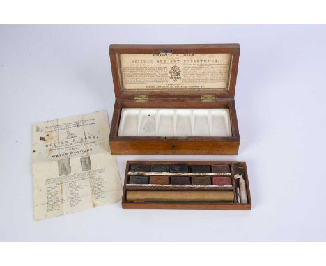 A Reeves and Son wooden Colour Box circa 1872, ten original paint cakes, second tray with porcelain six bay paint pallet, lid