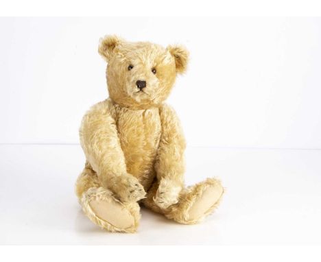 A fine 1930s Steiff teddy bear,  with golden mohair, clear and black glass eyes with brown backs, pronounced muzzle, black st