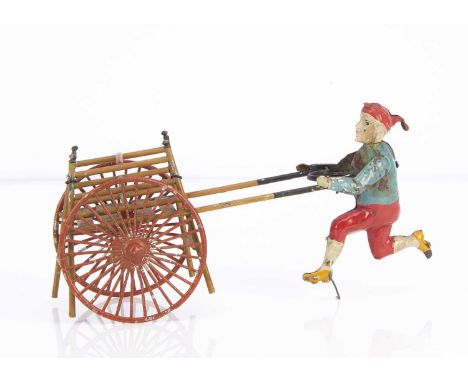 A German painted tinplate boy pushing a passenger hand-cart,   the cart with two large red spoked wheels, a front and back fa