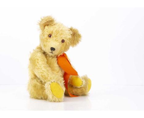 A 1930s teddy bear, with bright blonde mohair, orange and black glass eyes, pronounced muzzle with black stitched nose, mouth