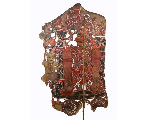 Three 1920s Rajasthan shadow puppets, hand-cut and painted velum, articulated with stick support, an Indian god on juggernaut