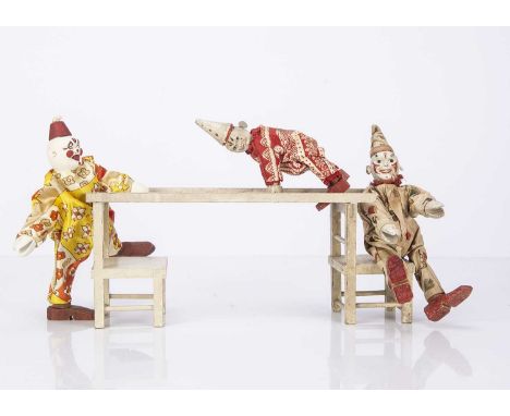Three Schoenhut Humpty Dumpty Circus clowns, a white faced clown with jointed wooden body and original costumed printed with 