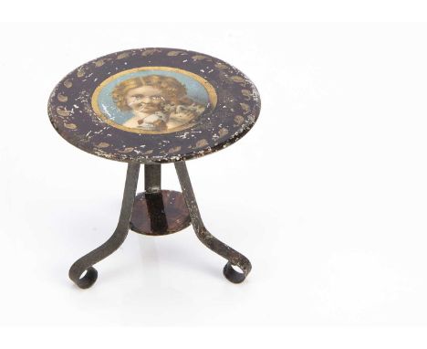 A German 19th century painted dolls’ house tripod table, painted brown with gold detail, the centre of the top with circular 