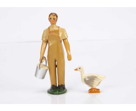 A Forest Toys of Brockenhurst land girl with bucket and goose, carved and painted wood, the girl with short brown hair, paint