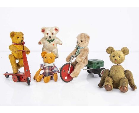 Five clockwork teddy bears,  including a light brown synthetic teddy bear on a tricycle, a golden art silk teddy bear on a re