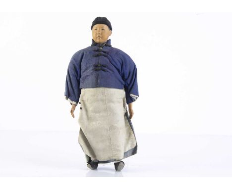 A Door of Hope Mission wooden male doll, with carved head and wooden hands, stuffed body, black painted side-parted hair, dar