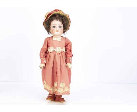 A Simon &amp; Halbig for Kämmer &amp; Reinhardt child doll, with blue sleeping eyes, brown curly mohair wig, pierced ears, jo