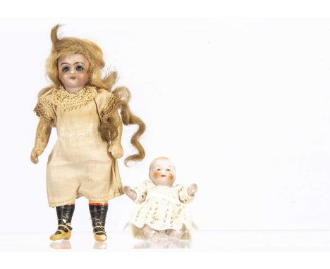 A German bisque headed dolls’ house doll,  with blue sleeping eyes, blonde mohair wig, jointed composition body with painted 