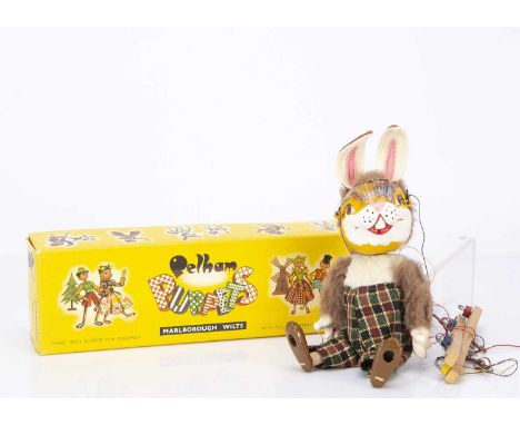 A rare Pelham Puppet SL Rabbit 1963, with felt ears and checked trousers, in original yellow box with end stamp ‘Rabbit’