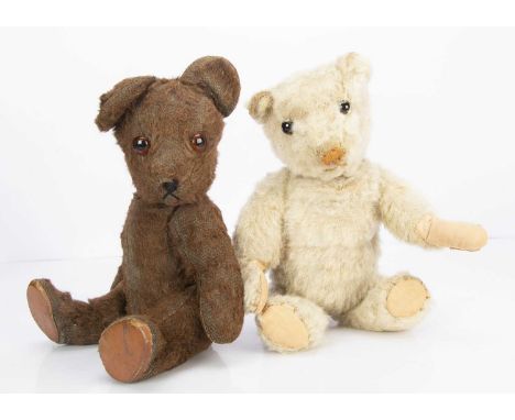 A British 1930s teddy bear cub, with beige wool plush, clear and black glass eyes with remains of brown painted backs, light 