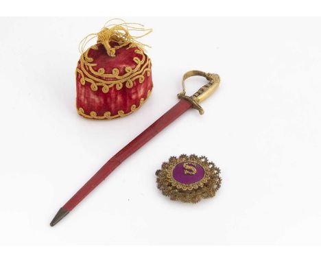 A 19th century red velvet fez pen wipe,  with gold coloured thread decoration, tassel and pinked cloth sheets attached to ins