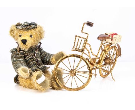 A Nessa Bears artist teddy bears, Monty in green knitted outfit and card tag, ridding a golden bicycle —16in. (41cm.) high; a