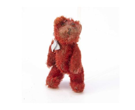 A rare Farnell red mohair WWI soldier teddy bear, with orange and black glass eyes, painted nose, pipe-cleaner ears, swivel h