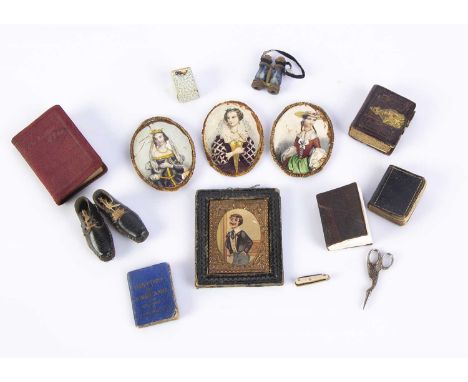 Miniature items for the dolls’ house or fashion doll, a leather bound photograph album with gilt metal clasp —1 1/2in. (4cm.)