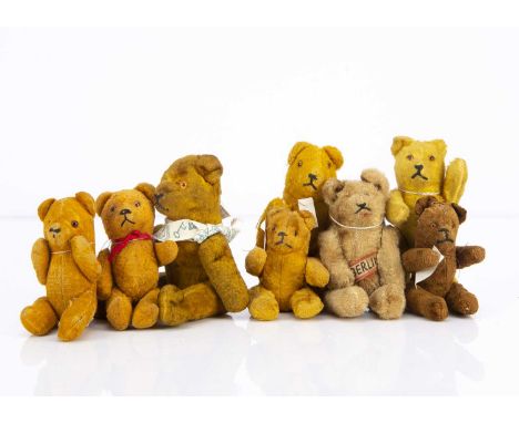 Eight small German post-war pin-jointed teddy bears,  including a light brown synthetic teddy bear with orange and black plas