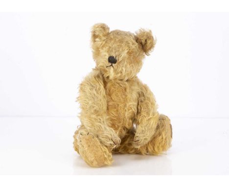 A 1930s Farnell teddy bear,  with golden curly mohair, black stitched nose, mouth and claws, swivel head, jointed limbs, inop