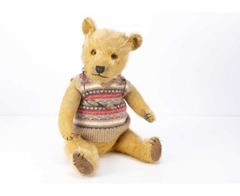 A 1950s Chiltern Hugmee teddy bear, with golden mohair, orange and black glass eyes, black stitched nose, mouth and claws, sw