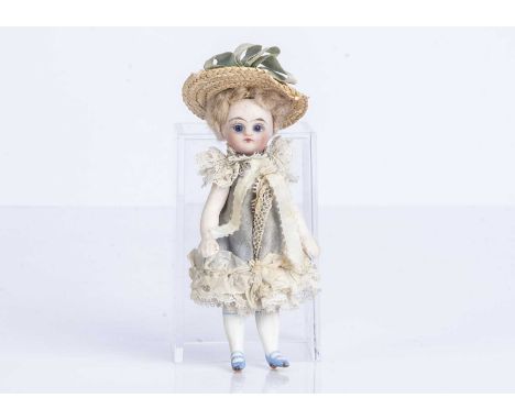 An all-bisque dolls’ house doll or Mignonette,  with dark blue eyes, closed mouth, blonde mohair wig, socket head impressed 4