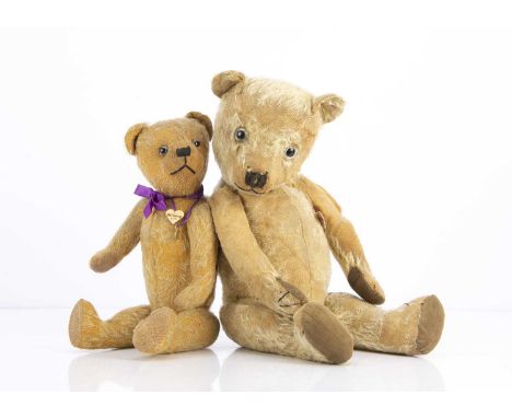 Two 1930s Chiltern type teddy bears,  the smaller with blonde mohair, clear and black glass eyes, remains of painted backs, b