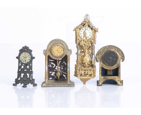 German metal dolls’ house clocks,  a gold painted soft metal wall clock with pendulum —3 3/4in. (9.5cm.) high, a soft metal m