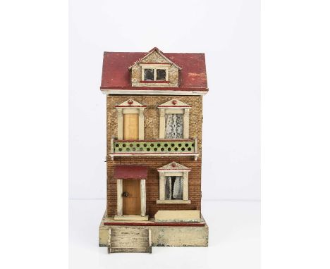 A German late 19th century red roof dolls’ house seaside villa from the Faith Eaton collection,  of printed paper over wood, 