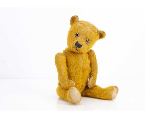 A 1930s Chiltern type teddy bear,  with rich  golden mohair, clear and black glass eyes with remains of painted backs, black 