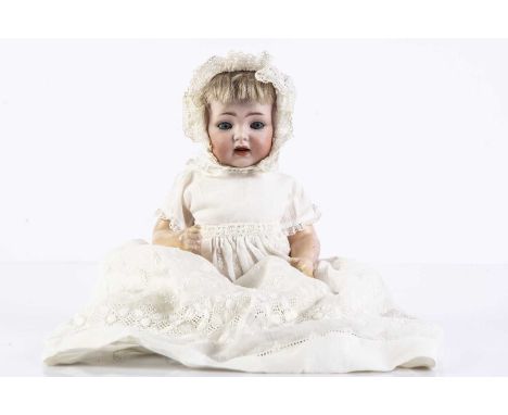 A small Kammer & Reinhardt 122 character baby, with blue sleeping eyes, blonde mohair wig, bent-limbed composition body, musl