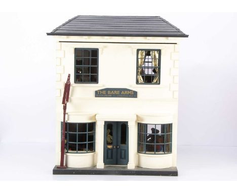 The Bare Arms teddy bear pub, painted white with central front door, four windows, opening to reveal two large rooms, with ce