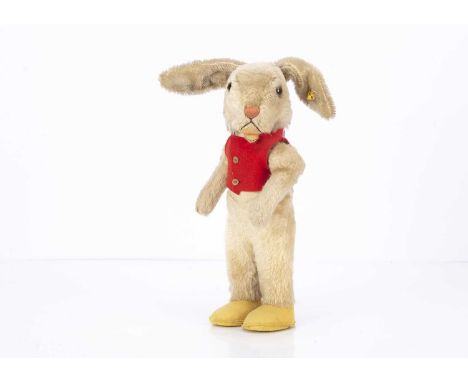 A post-war Steiff Nikili rabbit boy,  with swivel head, jointed arms, yellow felt shoes, red waistcoat and script button with