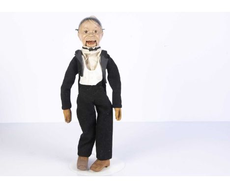 A composition headed toy Charlie McCarthy ventriloquist puppet, with painted brown eyes, articulated and hard carved wooden b