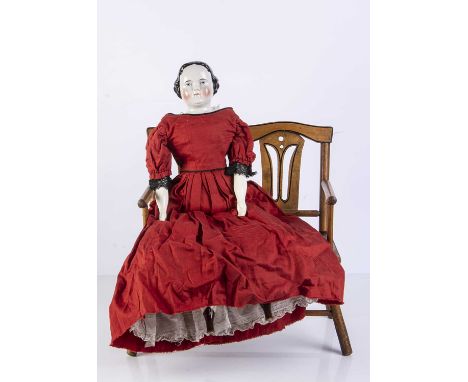 A 19th century German china shoulder-head doll,  with blue painted eyes, white highlight toy and red eyelid line, black paint