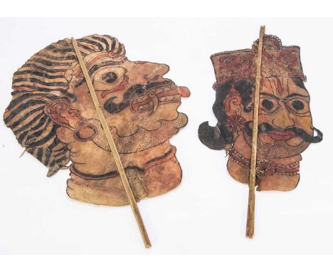 Two 1920s Rajasthan shadow puppet heads, hand-cut and painted velum on stick support —25in. (63.5cm.) largest (slight wear)
