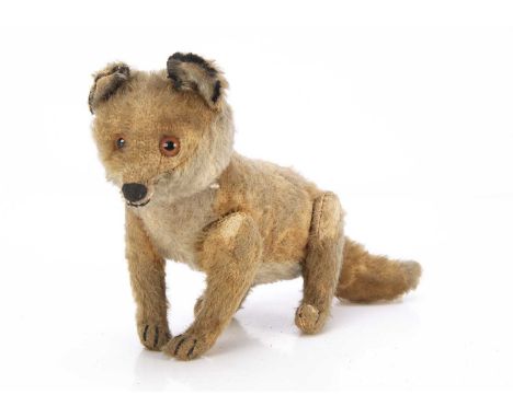A Steiff jointed fox circa 1912, with reddish brown and white mohair, orange and black glass eyes, black stitched nose mouth 