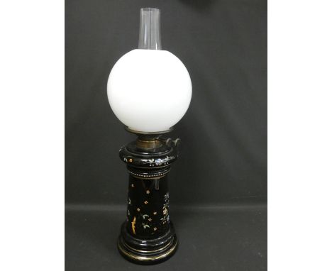 Victorian duplex paraffin table light with opaque milk glass globe, the black glass base decorated with flowers and creeping 