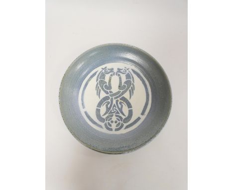 Caerfarchell studio pottery charger, the top decorated with stylised celtic entwined horses on a blue and white ground. Signe