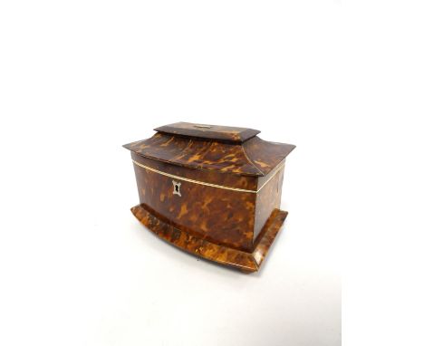 Tortoiseshell and ivory inlaid tea caddy, circa early 19th century, of pagoda shape, the hinged top with monogrammed white me