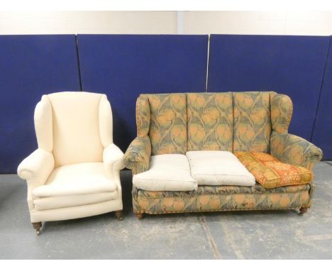 Edwardian scroll arm oak frame sofa raised on turned supports in the manner of Liberty, upholstered in William Morris fabric.