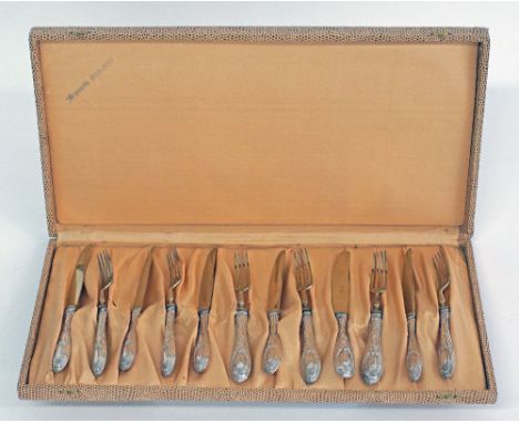 A German silver set of six desert knives and forks, the upper part gilded. Hallmarked Solingen 800. Weight 316g, L19,5cm the 