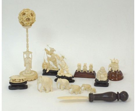 A collection of Chinese ivory carvings comprising of a reticulated ivory puzzle ball, the outer ball with dragons chasing the