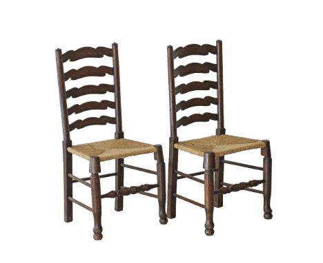 A pair of French antique provincial oak ladder chairs with rush seats, c1920s. H102cm (2).
