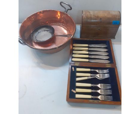 A Victorian copper twin handled cooking pot, cased fish knives and forks, a small frying pan and a walnut domed tea caddy lat