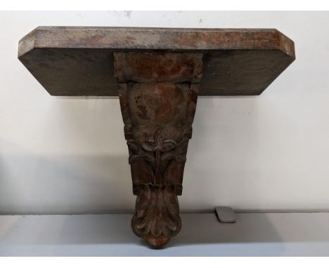 A late 19th century oak carved wall hanging bracket caned with flowers and C scroll, 36cm h x 47.5cm wLocation: 