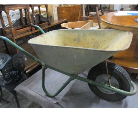 A vintage metal wheelbarrow Location: 